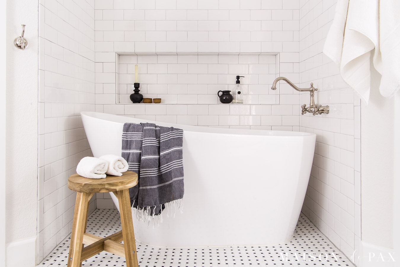 white slipper tub with large tiled tub shelf
