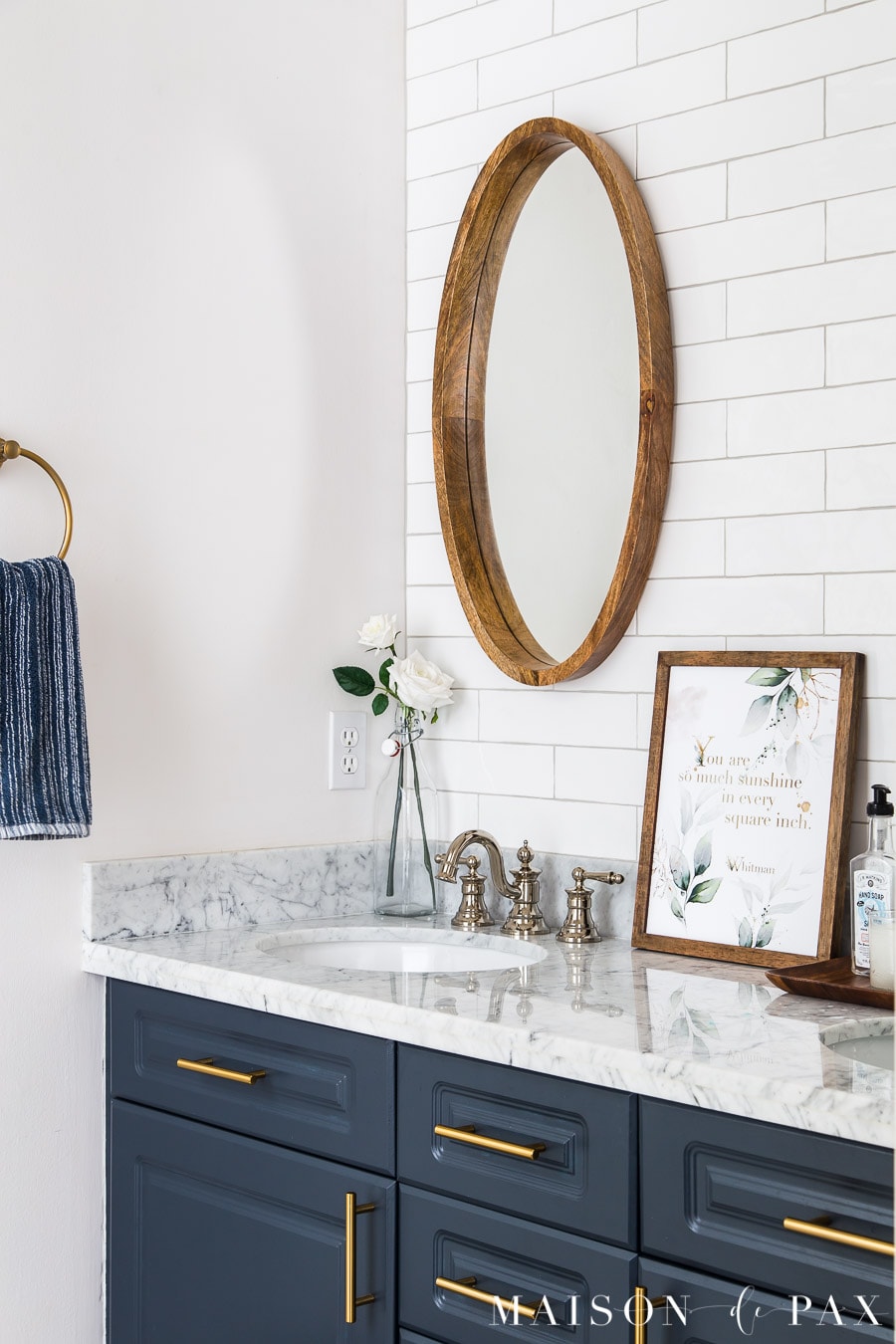 encouraging quote art on navy vanity with white tile wall and wood mirror | Maison de Pax