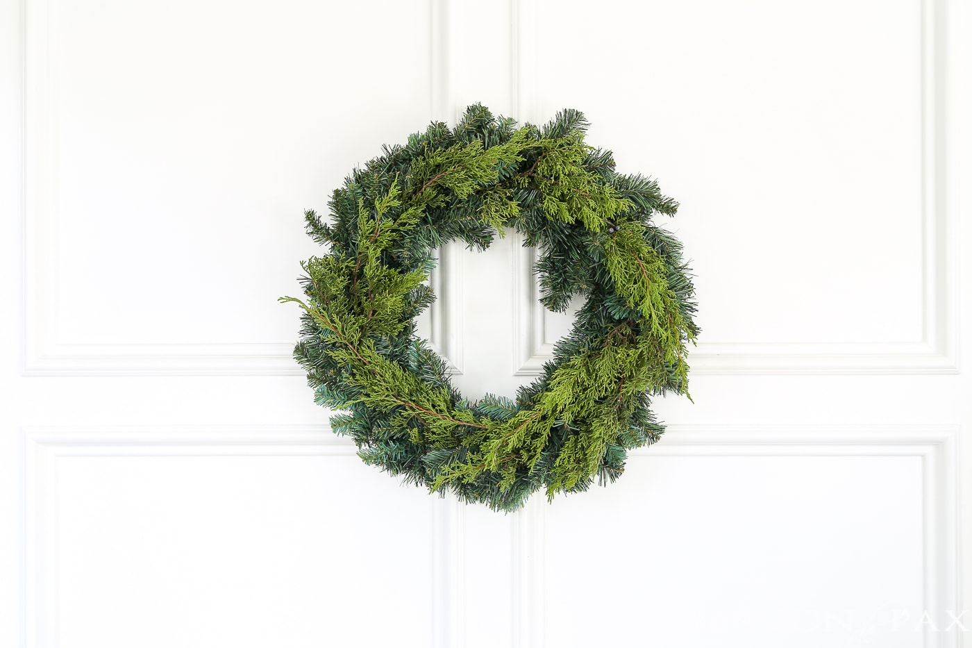 insert fresh greens into a cheap wreath to great a gorgeous, expensive look (and click for 4 other easy, affordable wreath ideas!) #christmaswreath