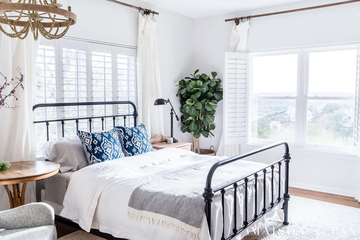 Mostly white master bedroom - so bright and open. Looking to add a seasonal touch to your bedroom?  Don't miss these incredibly simple master bedroom decorating ideas for spring! #springdecor #springbedroom #nightstand #modernfarmhouse