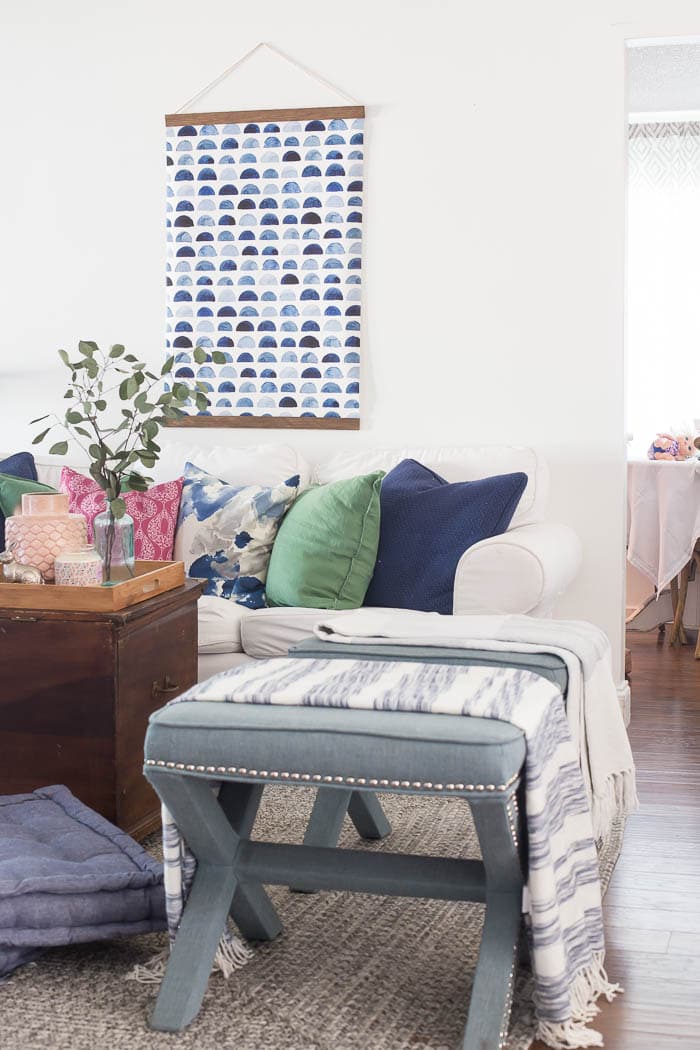 What a fun beachy vibe in this coastal living room! Blues, greens, weathered wood, and DIY wall art make it a beautiful, comfortable space.