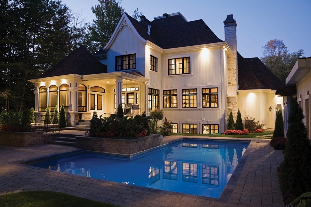 two story white home with big porch and black windows | Maison de Pax