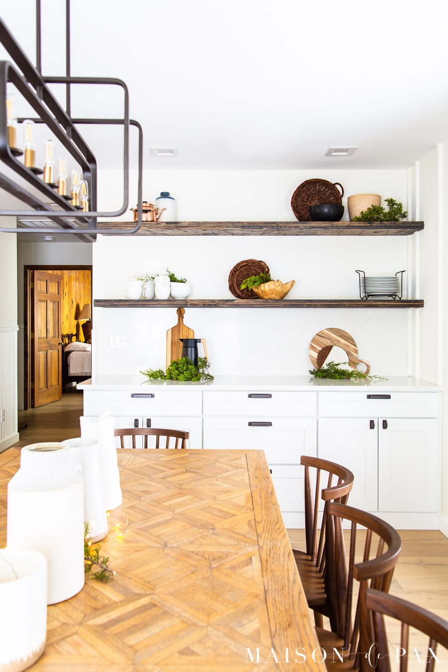 wood table with white pitchers and open shelving in dining room | Maison de Pax