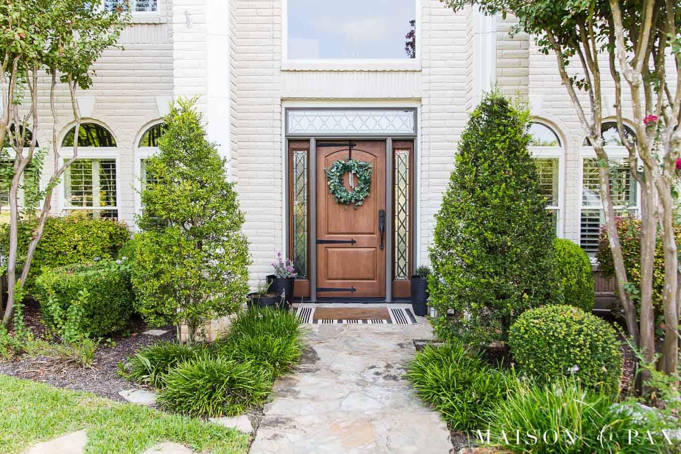black and white front porch decor on cream brick house | Maison de Pax