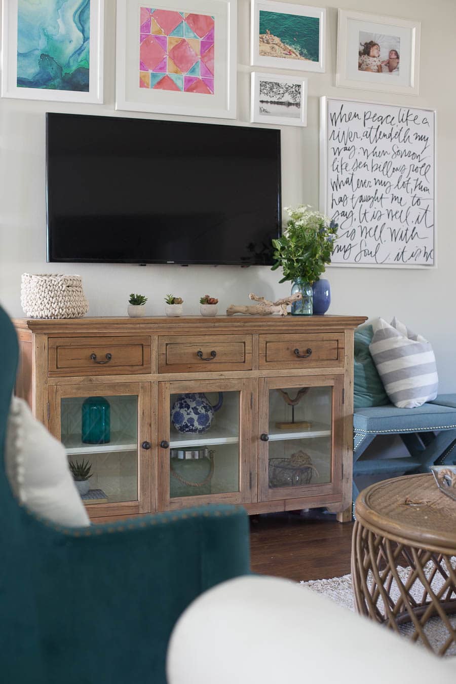 What a fun beachy vibe in this coastal living room! Blues, greens, weathered wood, and DIY wall art make it a beautiful, comfortable space.