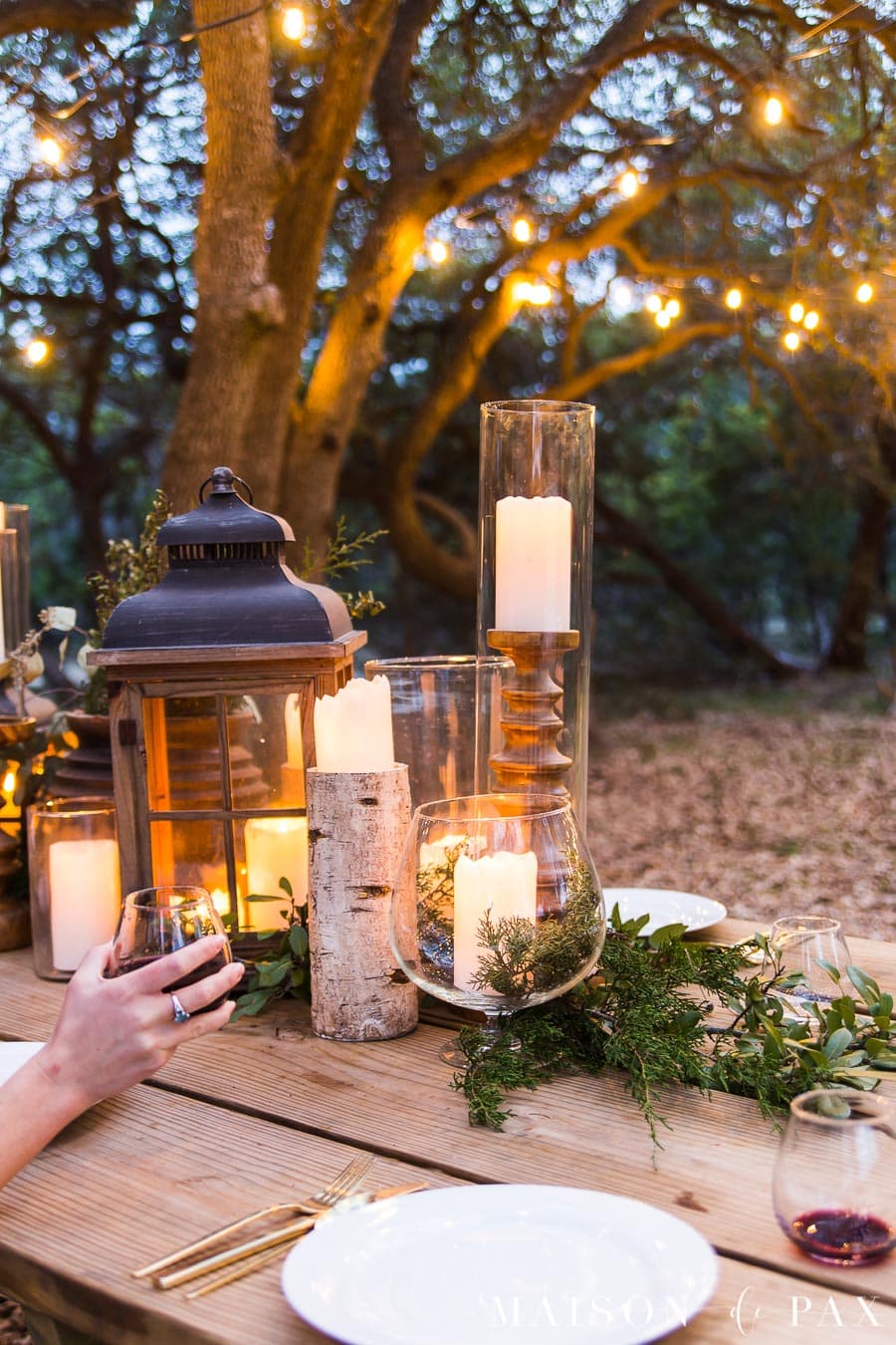 elegant candles and greenery on rustic outdoor dining table | Maison de Pax