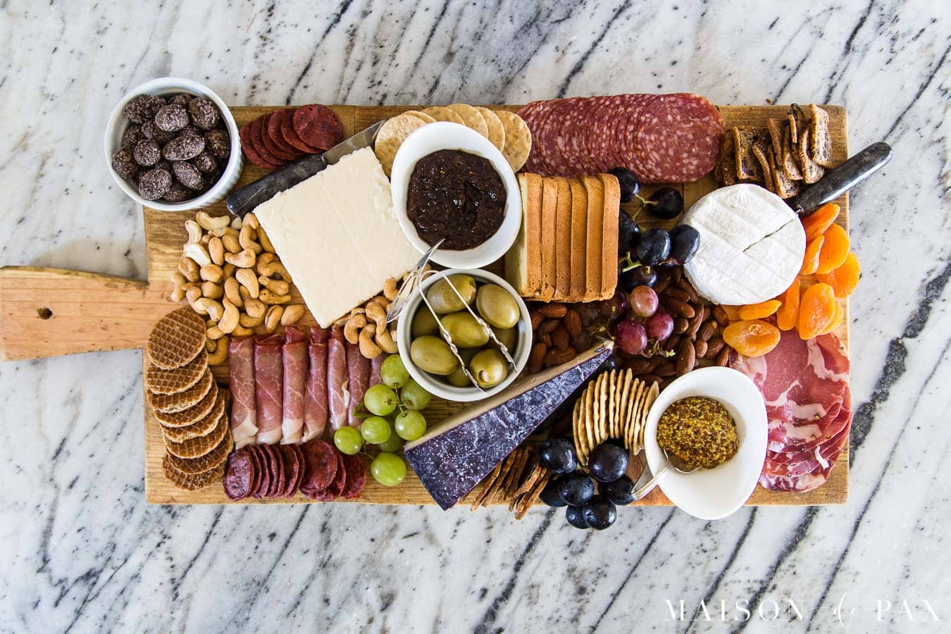 diy charcuterie board filled with cheeses, cured meats, dried and fresh fruits, and other treats | Maison de Pax