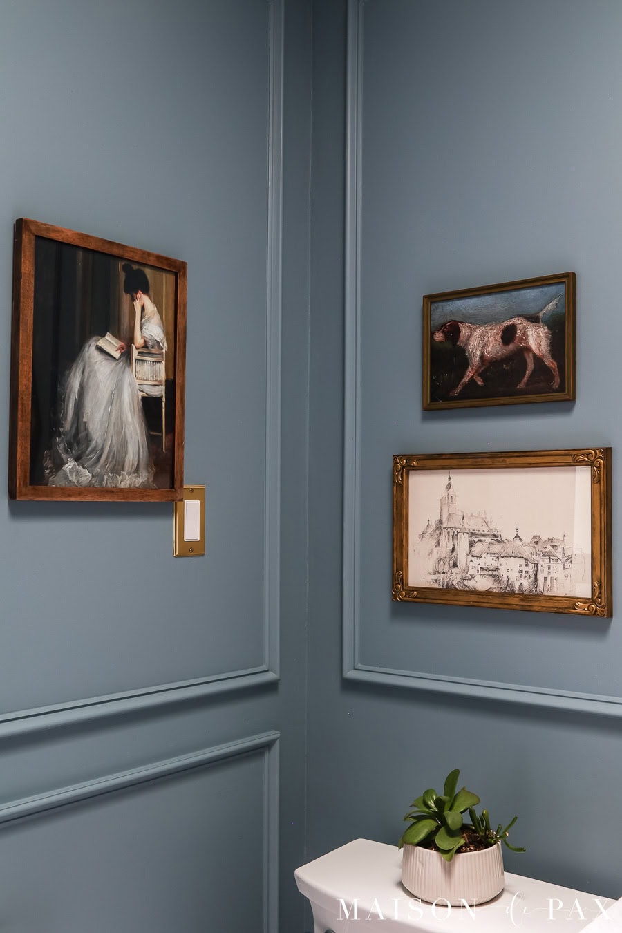 vintage art hung in bathroom