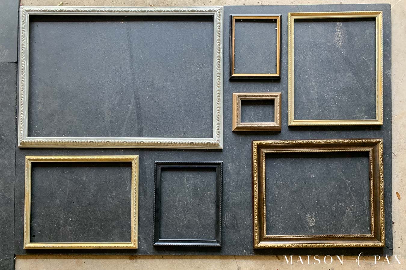 frames laid out in gallery wall format on ground | Maison de Pax