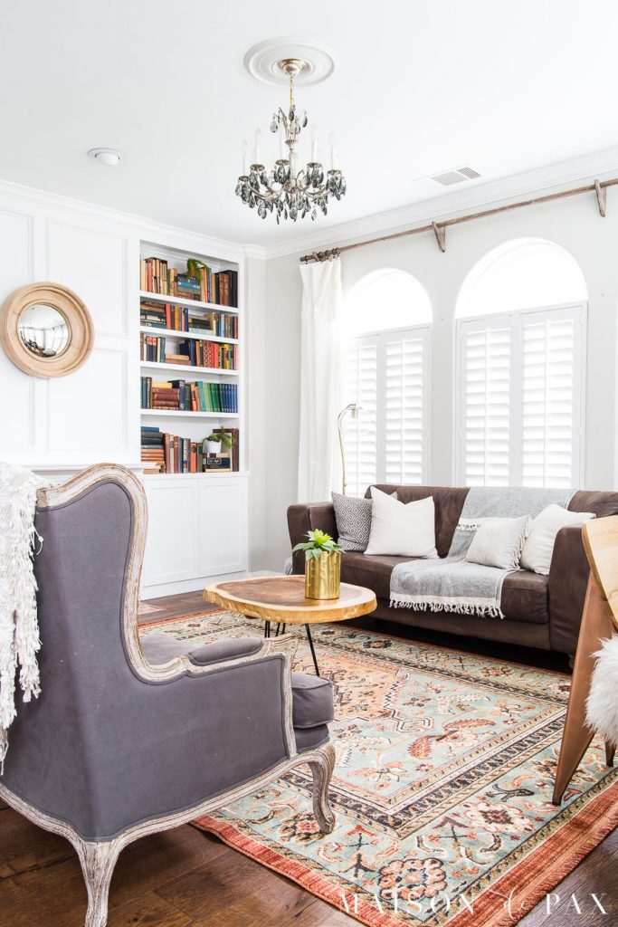 vintage rug look with antique books and modern accents living room | Maison de Pax
