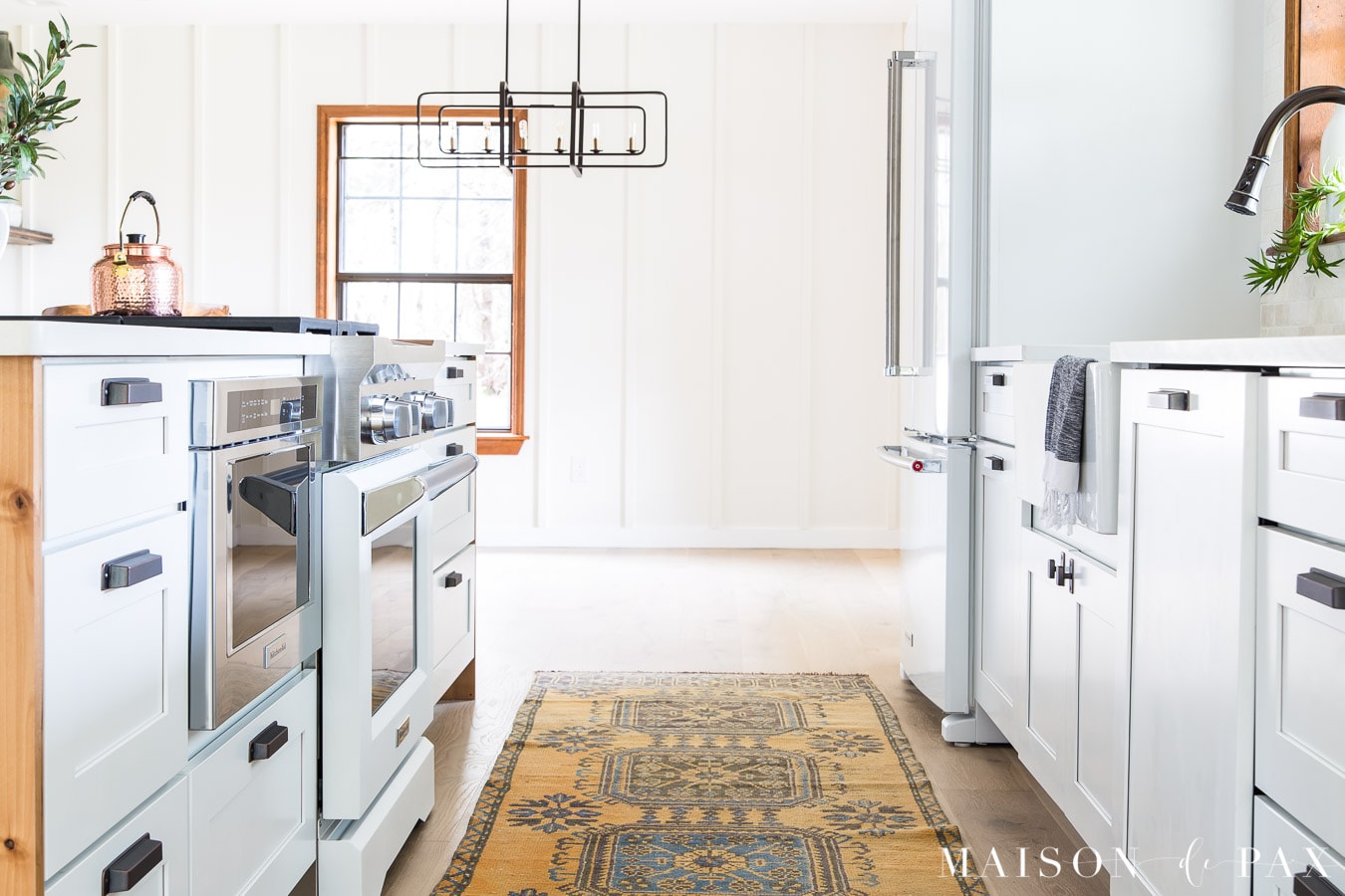 white kitchenaid fridge and commercial range with panel ready dishwasher and microwave drawer | Maison de Pax