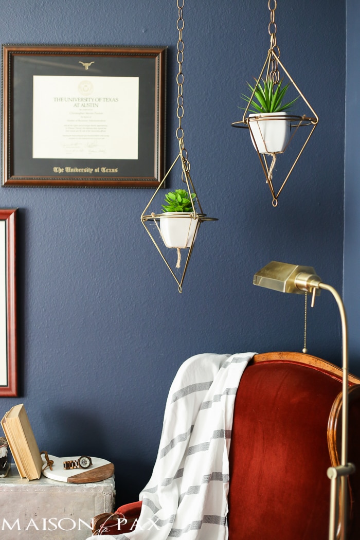 Love this dark, moody, navy office with red and brass accents
