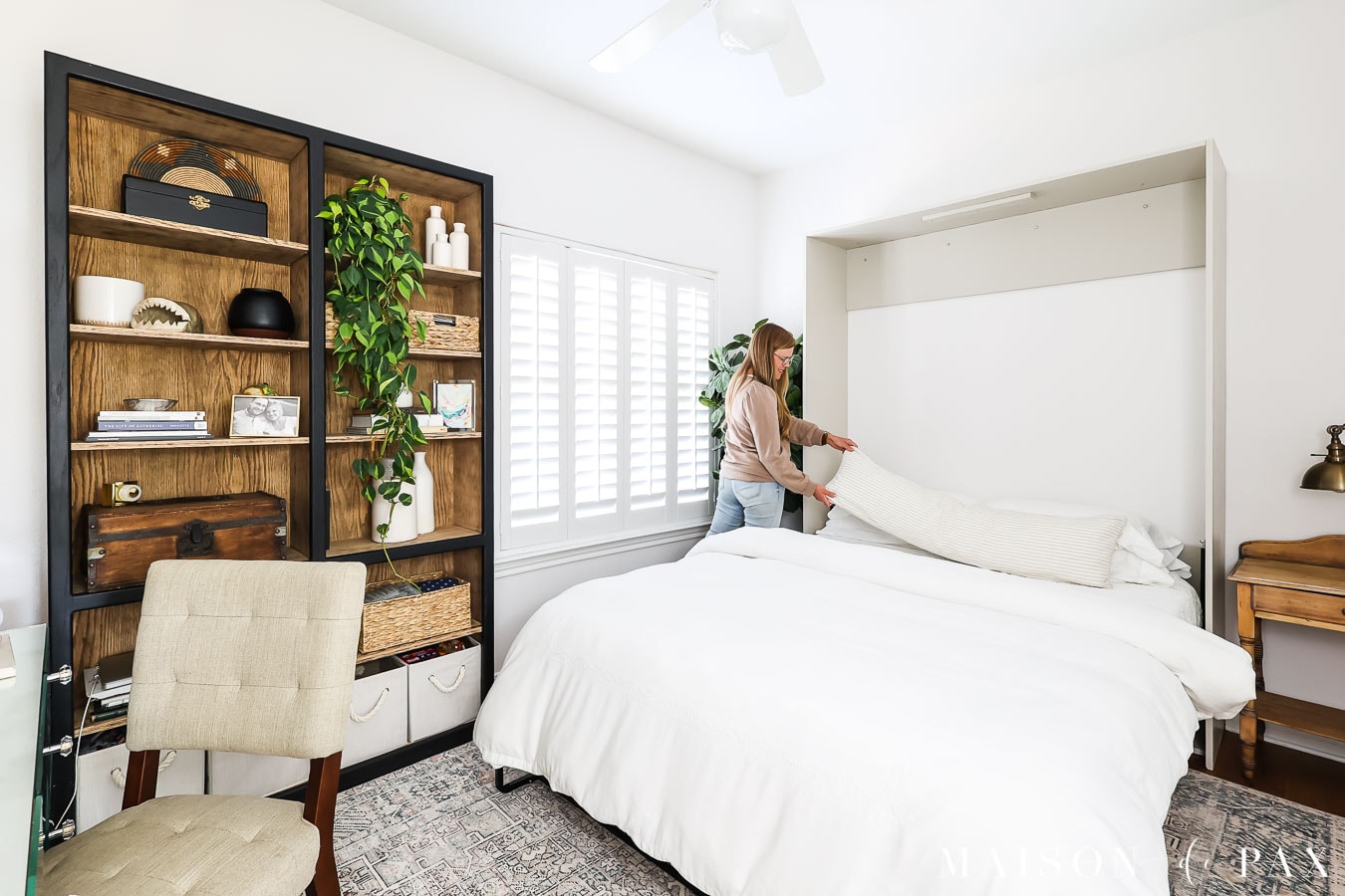woman making murphy bed with lumbar pillow