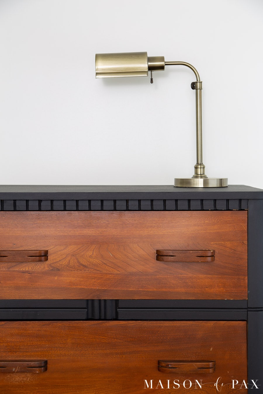 black matte dresser with rich brown wood drawers
