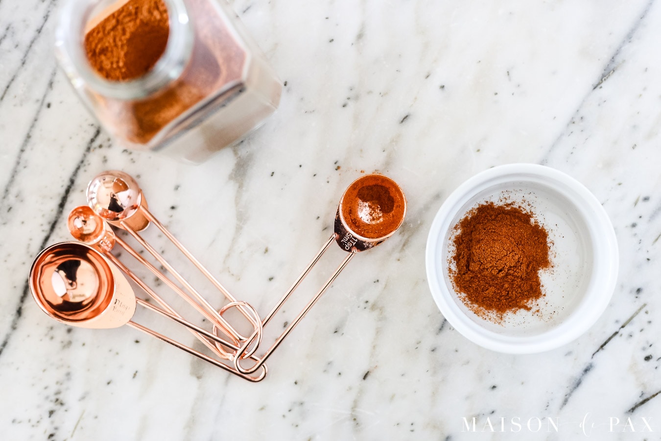 paprika and copper measuring spoons on marble