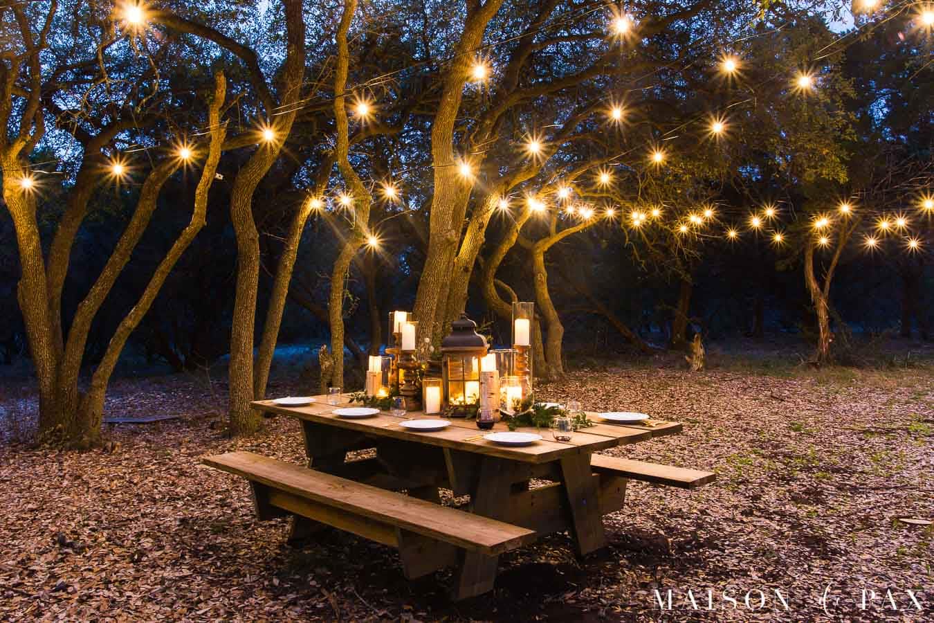 globe string lights over a giant picnic table | maison de pax