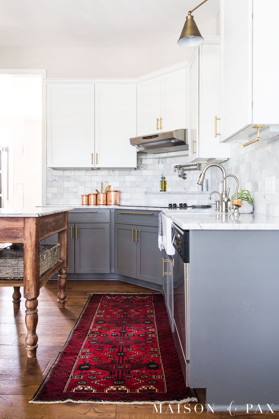 red vintage runner by kitchen sink and copper canisters on marble counters | Maison de Pax