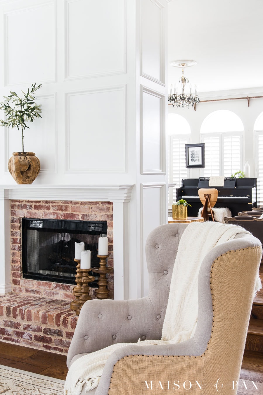 fireplace with white mantel and olive tree | Maison de Pax