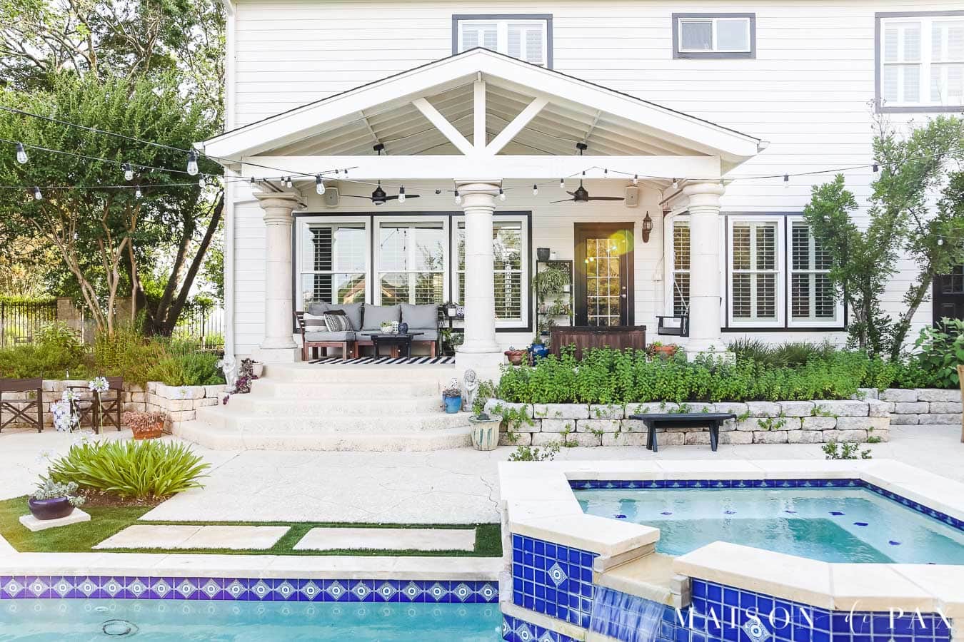 white house with black window trim, black door, and black outdoor fans