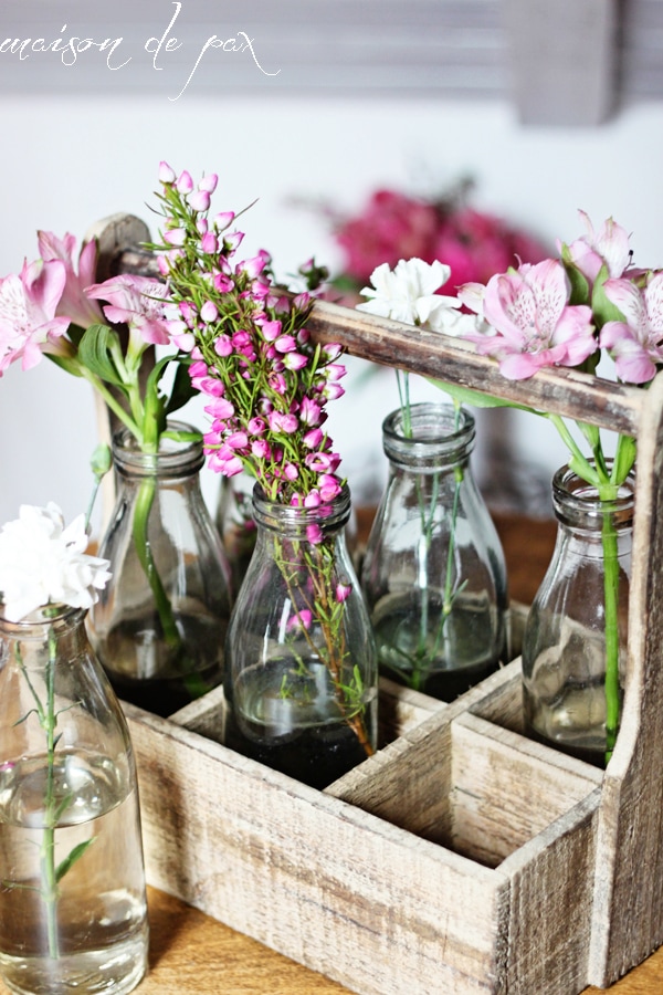 This stunning carrier made from reclaimed wood holds 6 antique milk bottles and makes the perfect rustic yet elegant piece of decor!