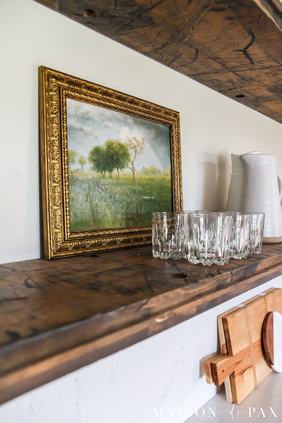 faux oil painting on open shelf in kitchen