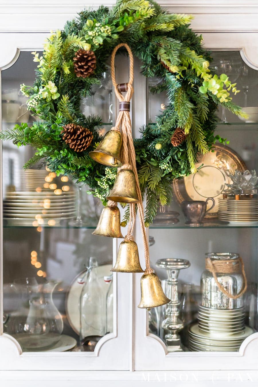 gold jingle bells on mixed green holiday wreath | maison de pax
