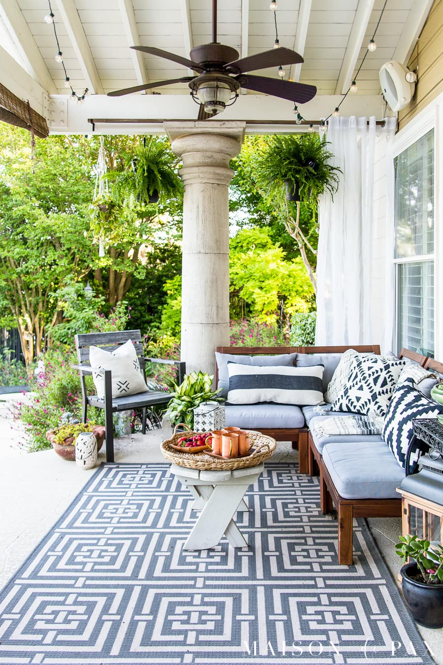 Beautiful summer patio with hanging ferns and blue and white patio furniture- Maison de Pax