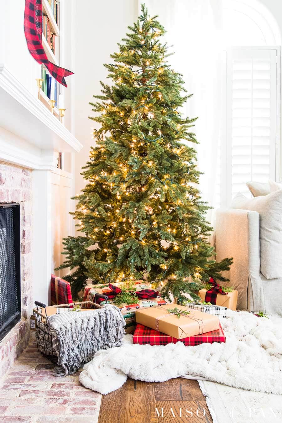 naked tree with white lights and beautiful wrapped gifts | Maison de Pax