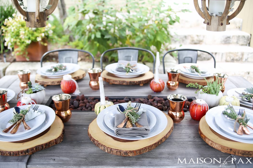 outdoor fall tablescape: lanterns, string lights, apple candles, and other cozy outdoor fall decorating ideas!