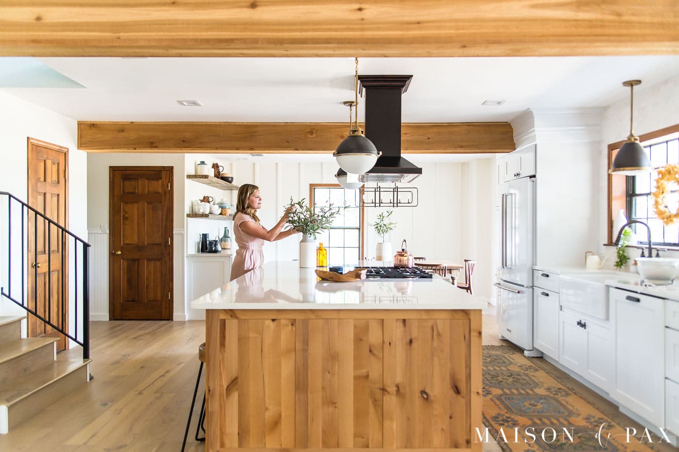 woman arranging fall foliage on kitchen island | Maison de Pax