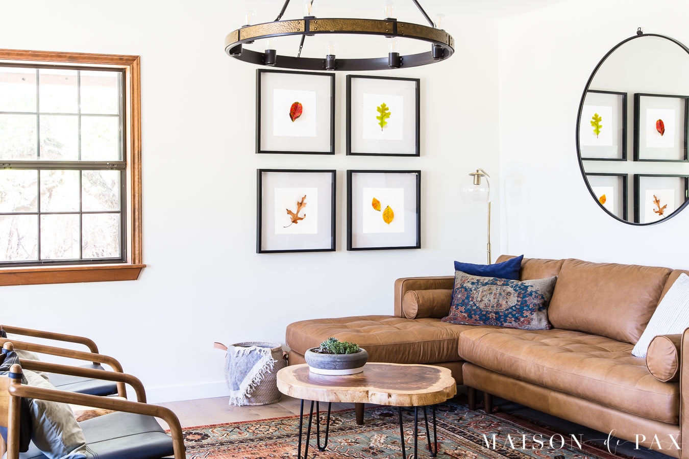 tan leather sofa, persian rug, and fall leaves as wall art | Maison de Pax