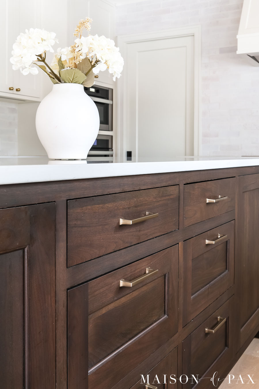 rich dark walnut wood kitchen island with white quartz countertops