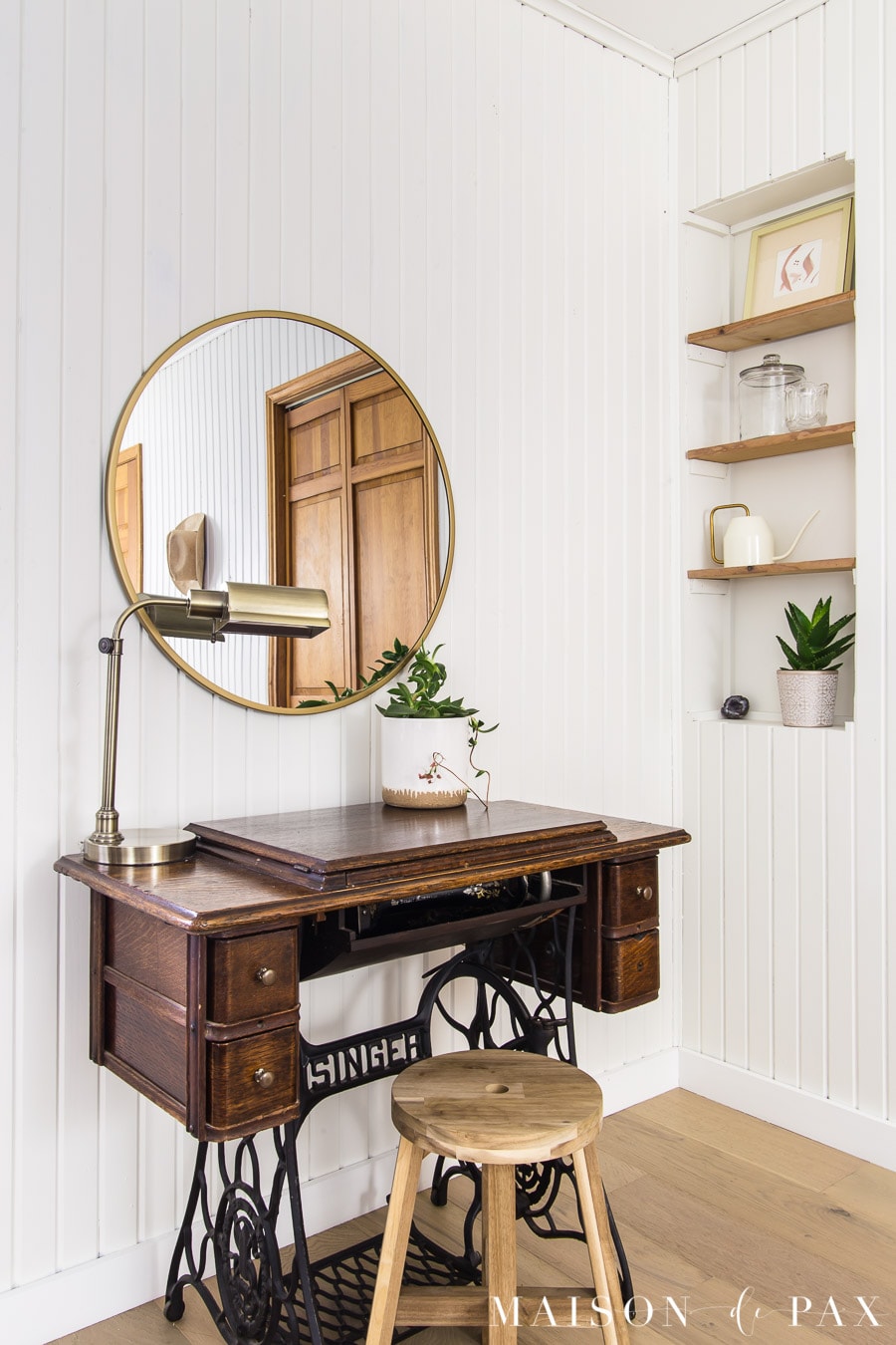 antique sewing machine with modern brass mirror above | Maison de Pax