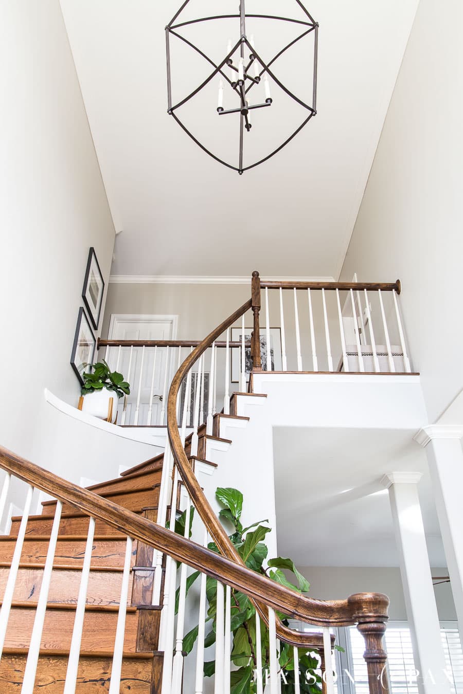 curved stairwell with simple lantern and artwork | Maison de Pax