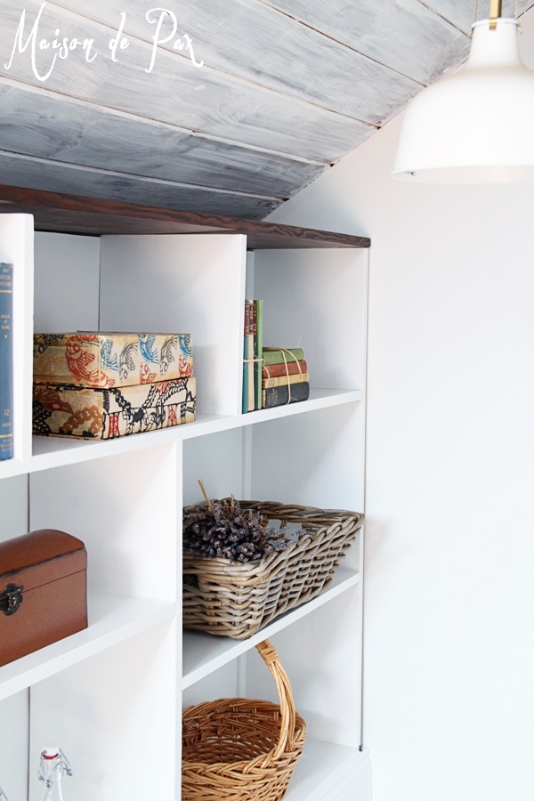 A DIY stairwell bookcase provides a creative and beautiful way to open the space and bring light into the stairwell.  Click through to see details and instructions!