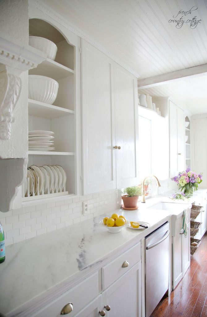 all white kitchen with beautiful marble countertops