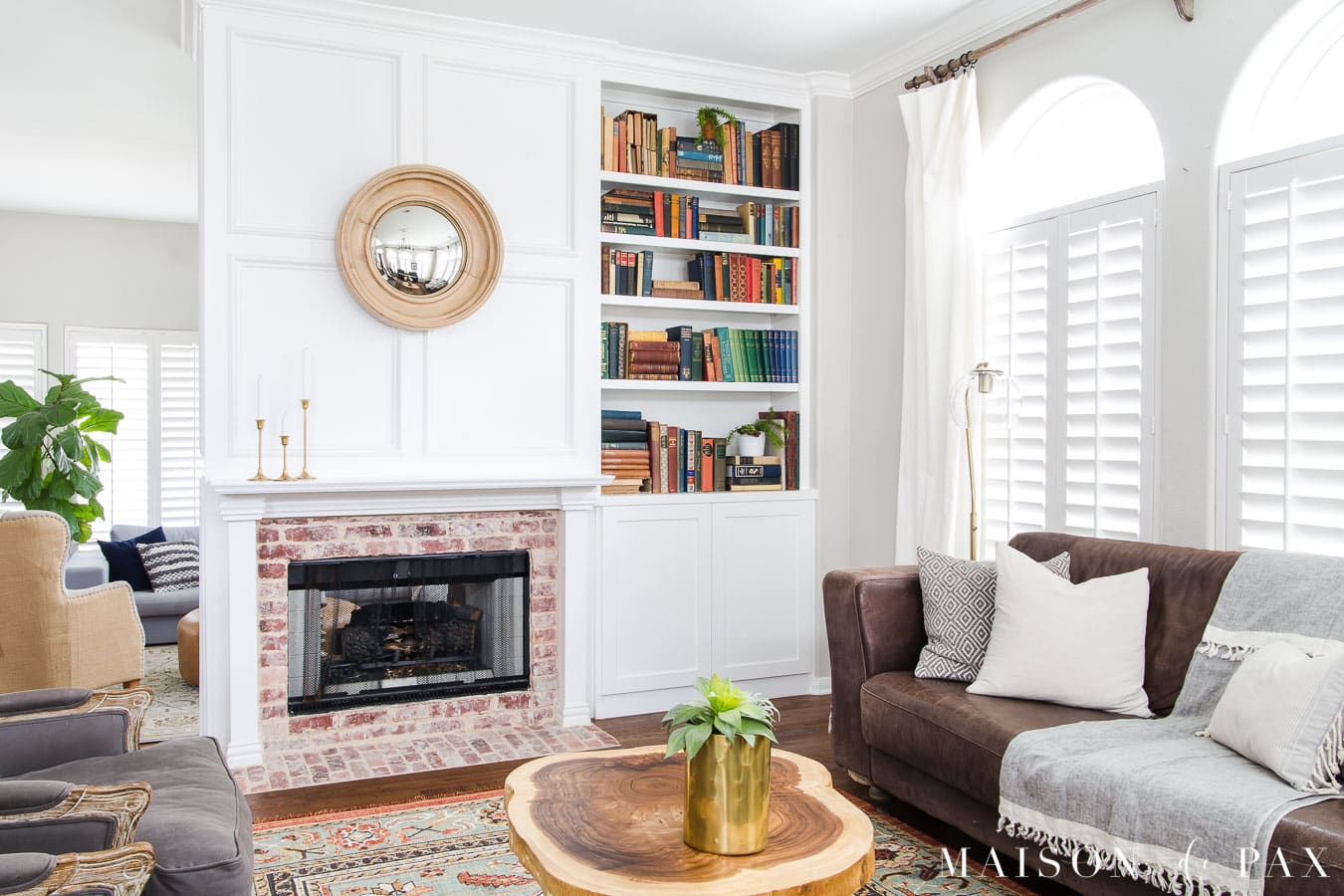 eclectic living room with fireplace and antique books | Maison de Pax