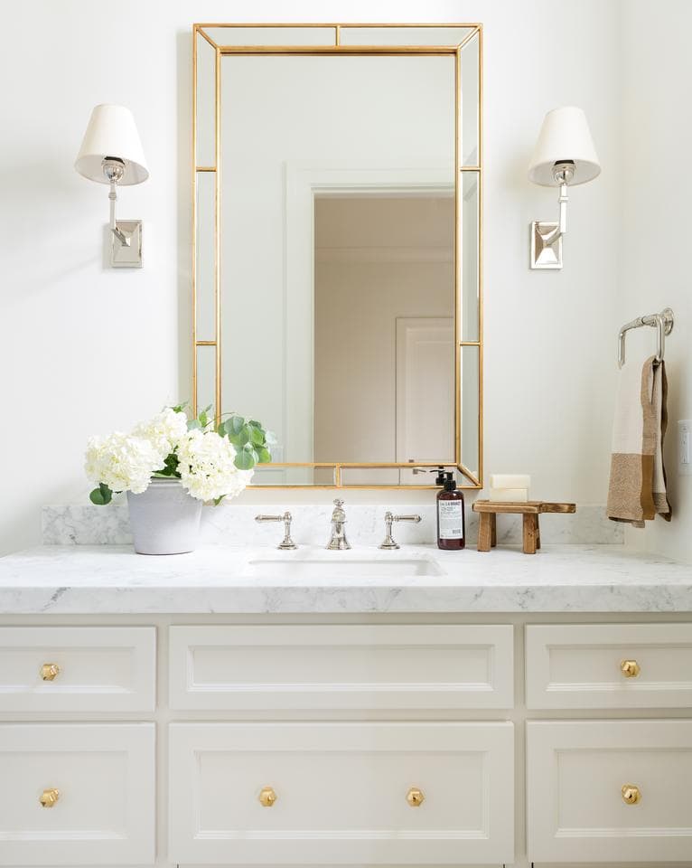 Beige painted bathroom vanity with mixed metal gold hardware and a marble top- Maison de Pax
