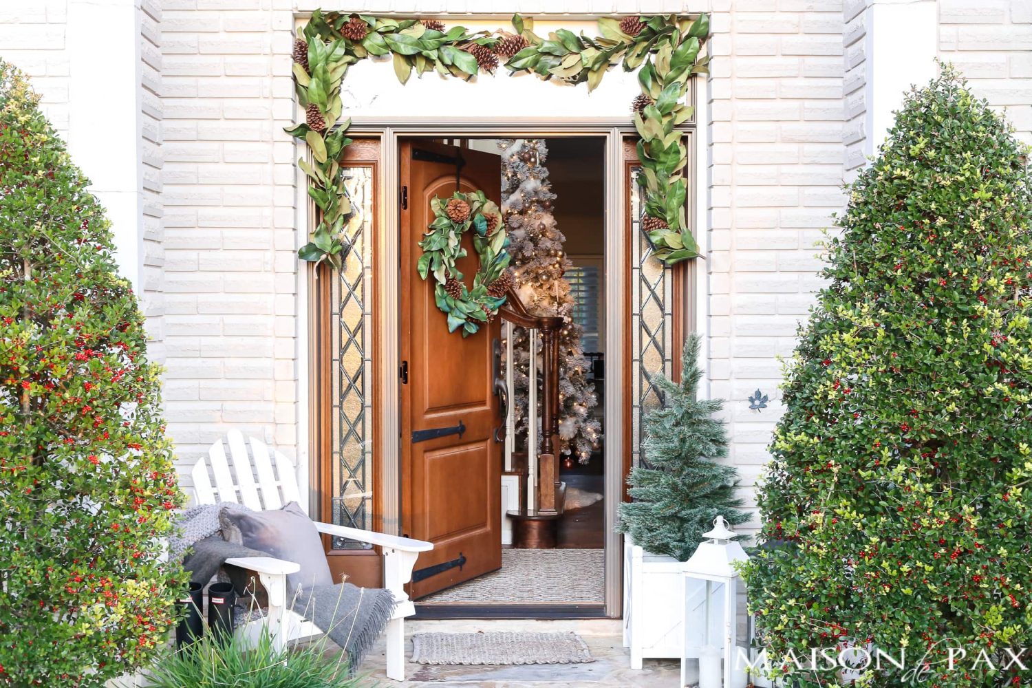 southern style winter porch: magnolia wreath and garland, adirondack chair, cozy accents #winterporch