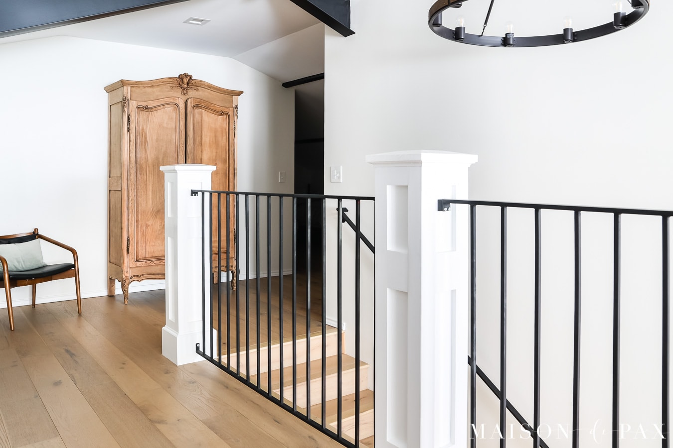 antique armoire at top of stairs