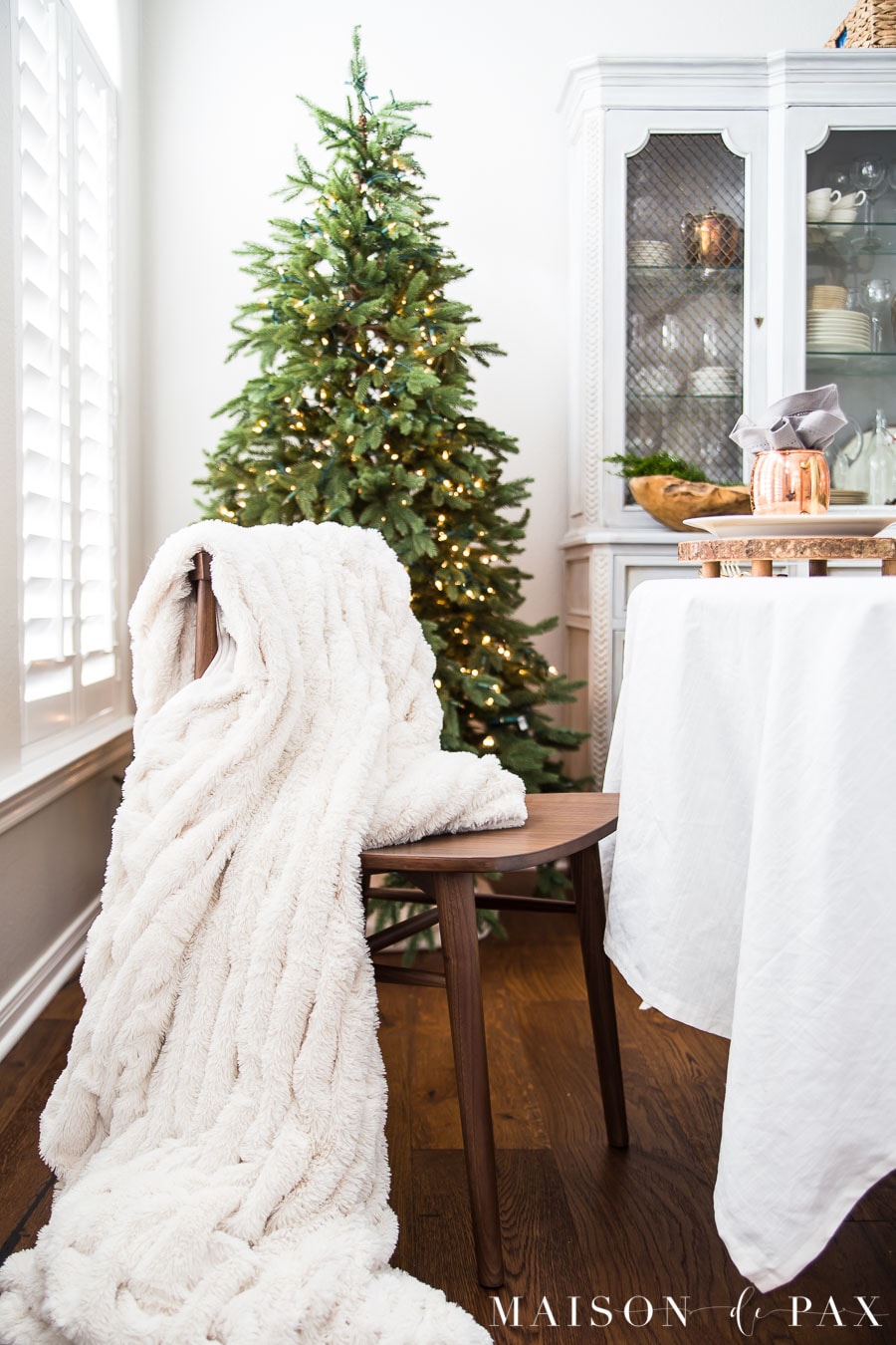 luxurious fur throw draped over a simple wooden dining chair