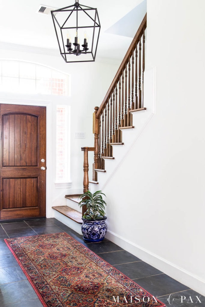 sw alabaster walls with extra white trim and wood staircase