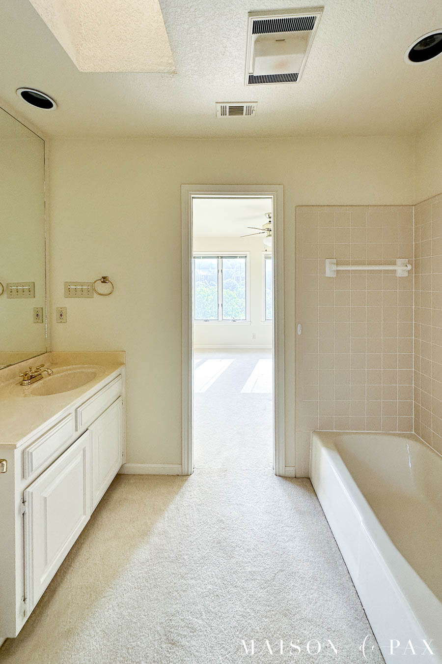 small 80s bath with carpet 
 and pocket doors before renovation