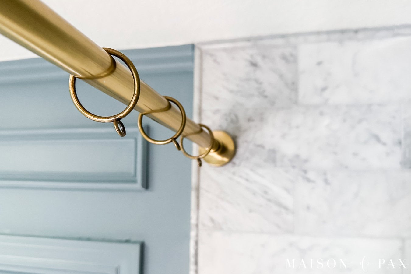 installing gold tension shower rod with curtain rings