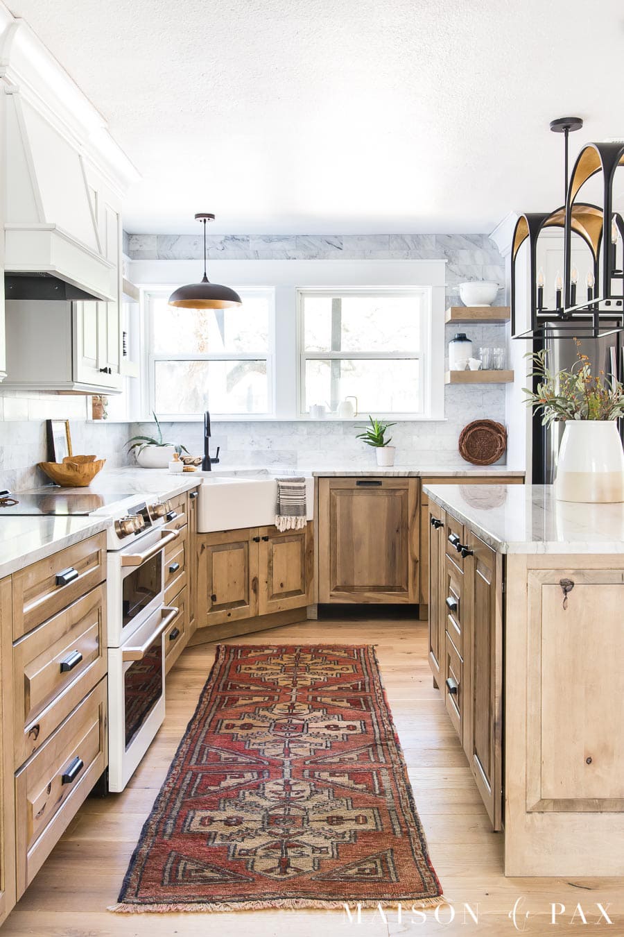 natural wood cabinets with marble backsplash