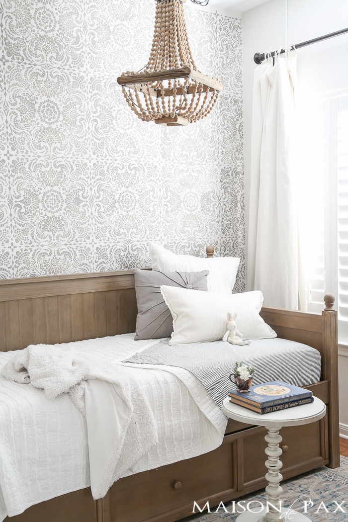 Elegant, neutral little girl room with wood tones and a stenciled accent wall: A gray-washed trundle bed provides the perfect anchor for a gorgeous, neutral yet feminine little girl's room.
