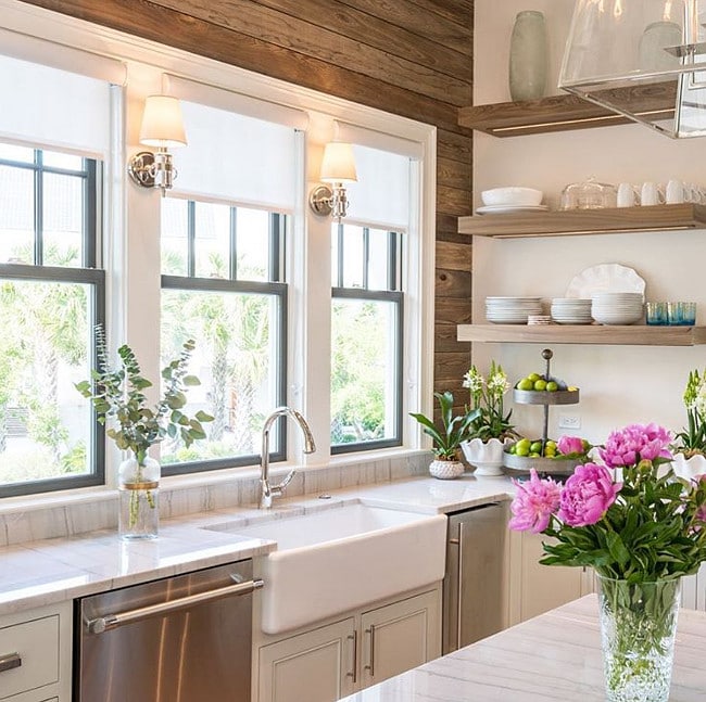 white kitchen with farmhouse sink and wood accent wall