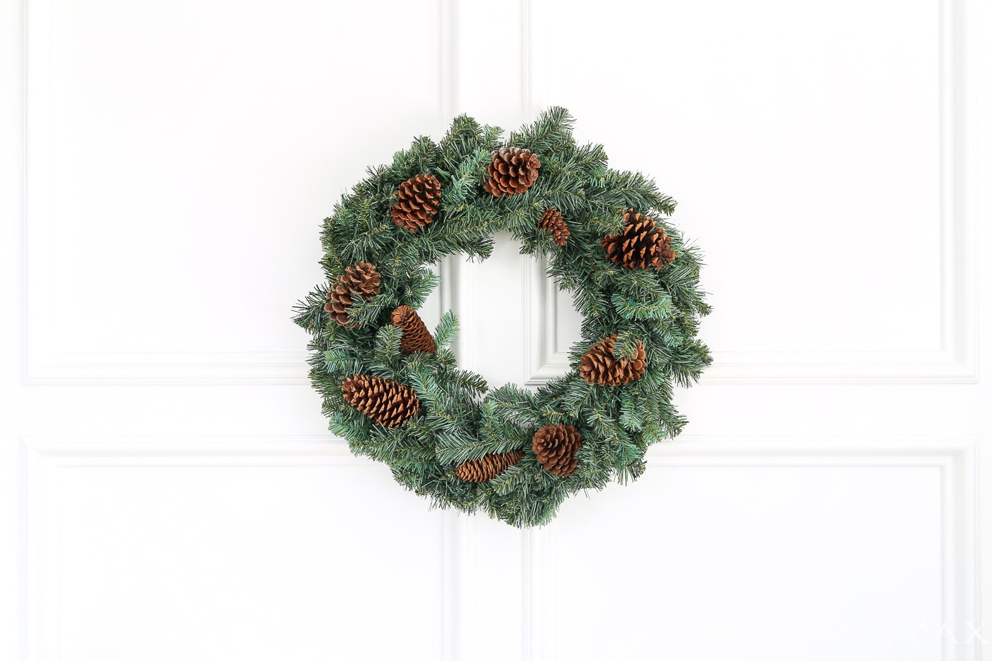 insert pine cones into a cheap wreath to great a gorgeous, expensive look (and click for 4 other easy, affordable wreath ideas!) #christmaswreath