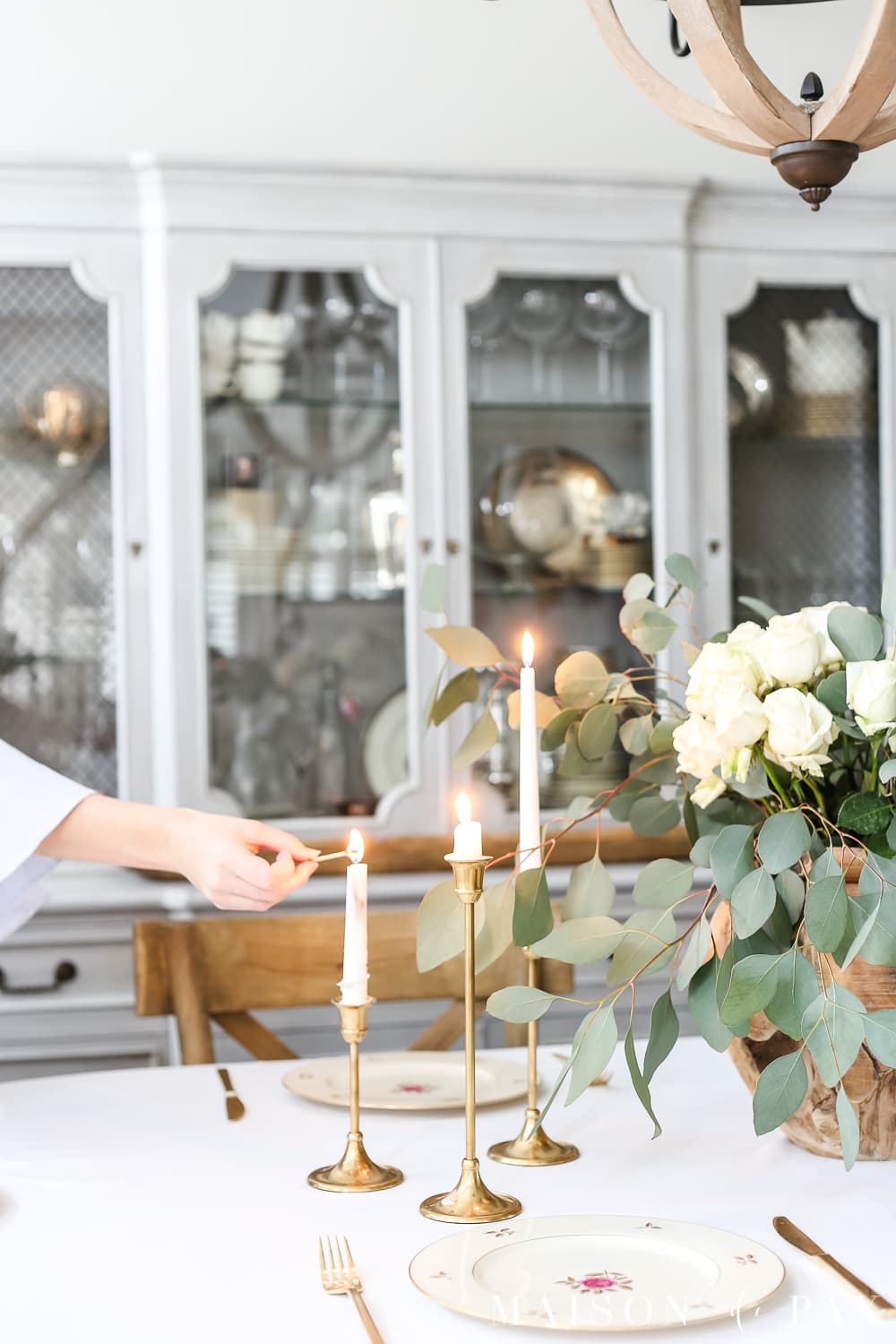 Beautiful brass candlesticks and white roses and eucalyptus centerpiece- Maison de Pax