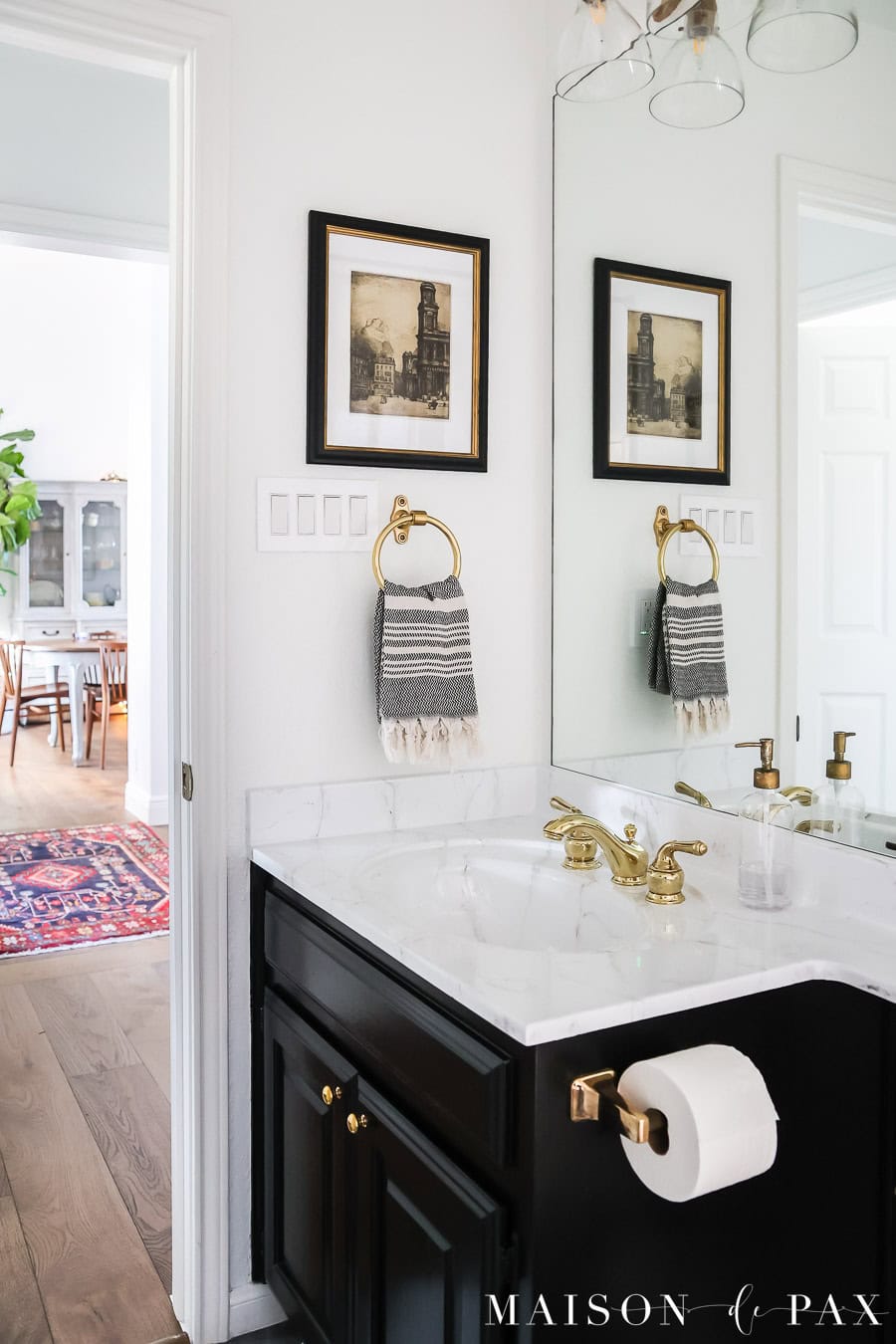 black and white classic bathroom looking out into living room with persian rug